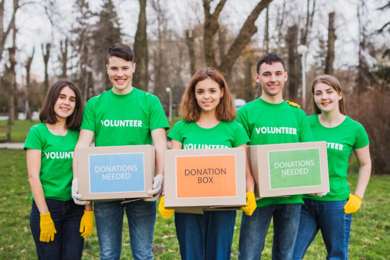 environment volunteer concept with persons holding boxes donations 768x512