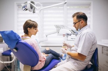 male professional dentist with gloves mask discuss 2